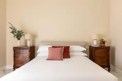 a bedroom with a white bed with two night stands at Casa Gold by Hili in Rome