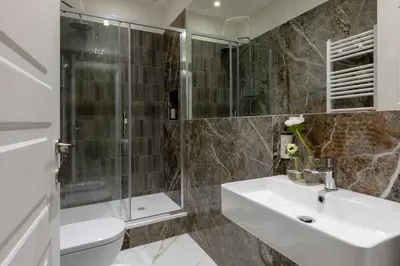 a bathroom with a sink and a shower and a toilet at Casa Gold by Hili in Rome