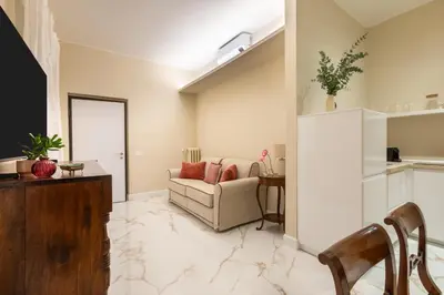 a living room with a couch and a table at Casa Gold by Hili in Rome