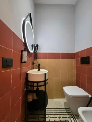 a bathroom with a sink and a toilet at Victoria Suites in Rome