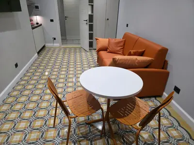 a living room with a table and a couch at Victoria Suites in Rome