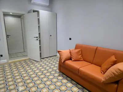 a living room with a couch and a closet at Victoria Suites in Rome