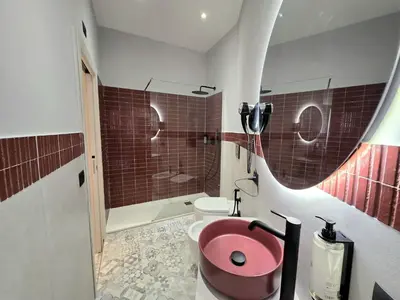 a bathroom with a pink toilet and a shower at Victoria Suites in Rome