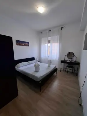 a bedroom with a bed in the middle of a room at Luma rooms in Rome