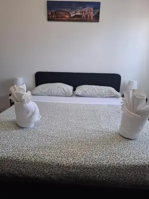 two white vases sitting on top of a bed at Luma rooms in Rome