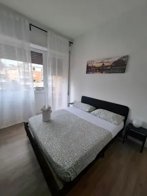 a bedroom with a bed and a window at Luma rooms in Rome