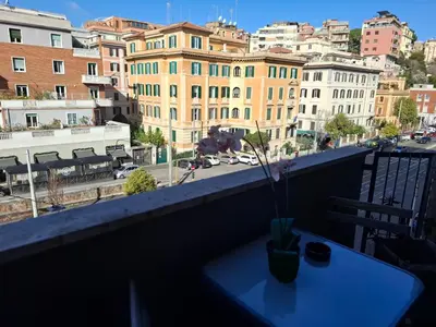 a table on a balcony with a view of a city at Luma rooms in Rome