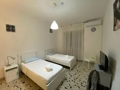 a bedroom with two beds and a tv in it at Tiburtina2000 in Rome