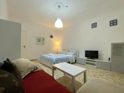 a living room with two beds and a couch at Tiburtina2000 in Rome