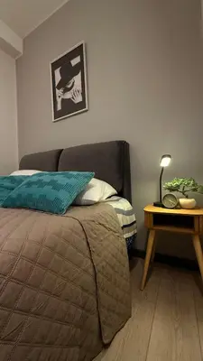a bedroom with a bed and a table with a lamp at Lucian Dreams roma in Rome