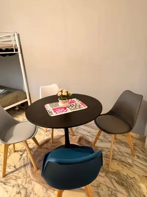 a table with two chairs and a table with a vase on it at Lucian Dreams roma in Rome