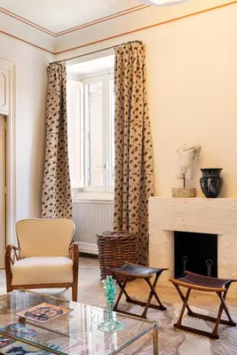 a living room with a chair and a fireplace at Idyllia - Casa Mina in Rome