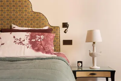 a bedroom with a bed and a table with a lamp at Idyllia - Casa Mina in Rome