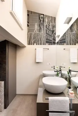 a bathroom with two sinks and two mirrors at Idyllia - Borgognona luxury home in Rome