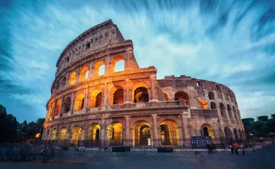 a view of the colosseum at night at Mari & Lucio Bright Rome Apartment Sleeps 4 near Metro Basilica San Paolo- 4 Stops to Colosseum- Wi-Fi AC in Rome