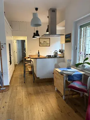 a kitchen with a table and a counter top at Urban Escape a Piazza Caprera in Rome