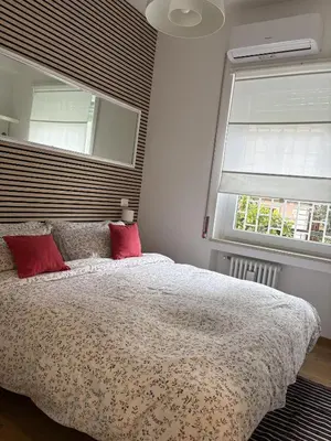 a bedroom with a large bed with red pillows at Urban Escape a Piazza Caprera in Rome