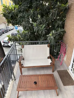 a bench on a balcony with a tree at Urban Escape a Piazza Caprera in Rome