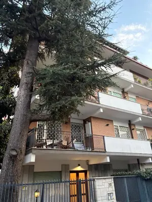 a building with a tree in front of it at Urban Escape a Piazza Caprera in Rome