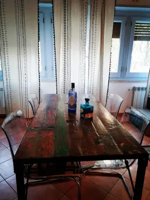 a wooden table with two bottles on top of it at A CASA di BICE in Rome