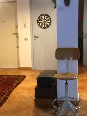 a room with a chair and a dart board on the wall at A CASA di BICE in Rome
