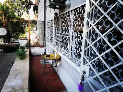 a patio with a table and a wall of wine bottles at A CASA di BICE in Rome