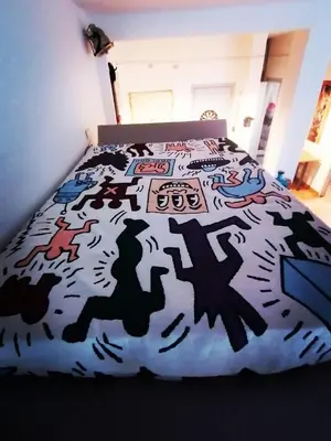 a bedroom with a bed with a black and white comforter at A CASA di BICE in Rome