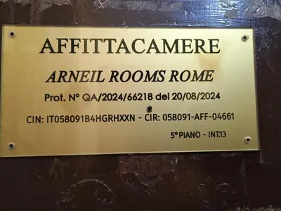 a sign on the side of a building that reads air filerate arrival roomsrano at Arneil Rooms Rome in Rome