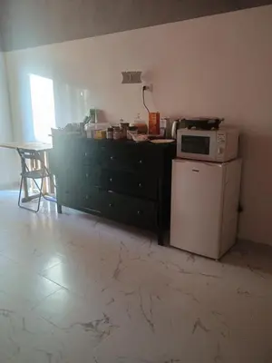 a kitchen with a black dresser and a microwave at Arneil Rooms Rome in Rome