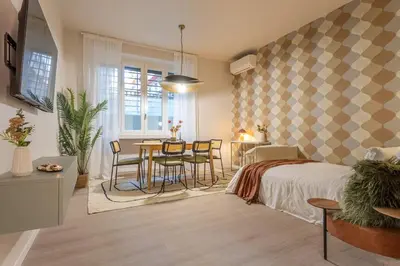 a bedroom with a bed and a table and chairs at BDC - Roman Lounge 3BDR at Vatican in Rome
