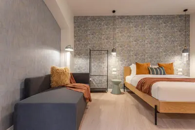 a bedroom with a bed and a couch at BDC - Roman Lounge 3BDR at Vatican in Rome