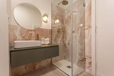 a bathroom with a sink and a mirror at BDC - Roman Lounge 3BDR at Vatican in Rome
