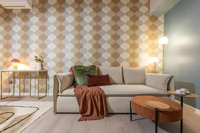 a living room with a couch and a patterned wall at BDC - Roman Lounge 3BDR at Vatican in Rome