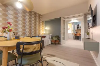 a room with a bed and a table and a bedroom at BDC - Roman Lounge 3BDR at Vatican in Rome