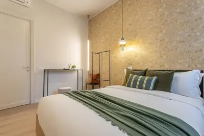 a bedroom with a large bed and a wall at BDC - Roman Lounge 3BDR at Vatican in Rome
