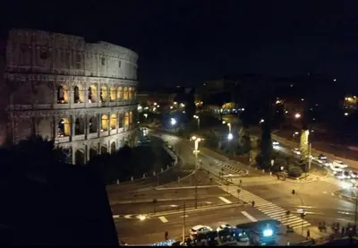a city at night with a building and a street at Colosseo28 three private rooms in Rome