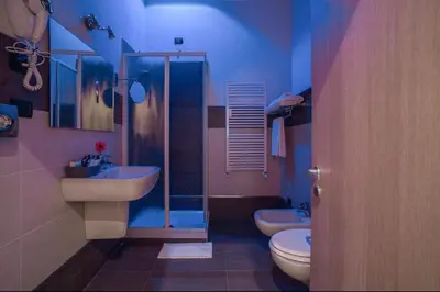 a bathroom with two sinks and a shower and two toilets at Colosseo28 three private rooms in Rome