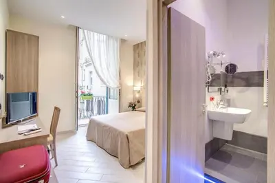 a hotel room with a bed and a sink at Colosseo28 three private rooms in Rome