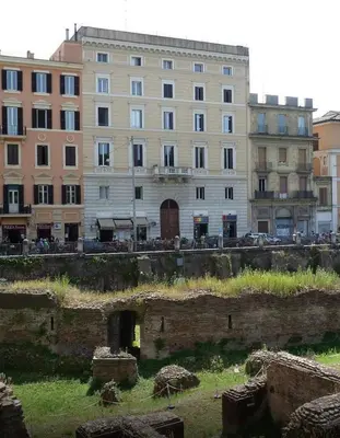 a large building in front of a building at Colosseo28 three private rooms in Rome