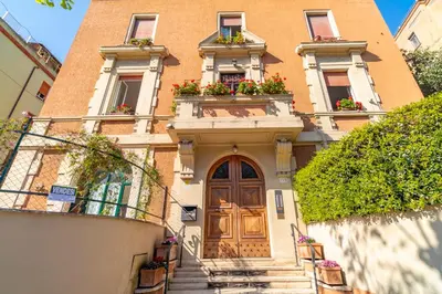a building with a door and flower boxes on it at Vatican House in Rome