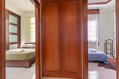 a bedroom with a bed and a wooden closet at Vatican House in Rome