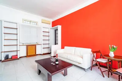 a living room with a white couch and a table at Vatican House in Rome