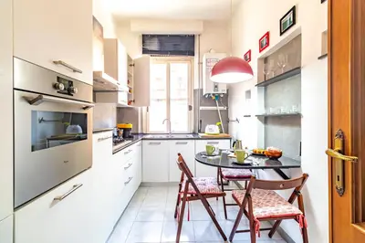 a kitchen with a table and two chairs and a table at Vatican House in Rome