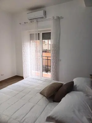 a large white bed in a room with a window at Ascenza in Trasteverere in Rome