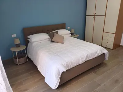 a bedroom with a large bed with white sheets and pillows at Ascenza in Trasteverere in Rome