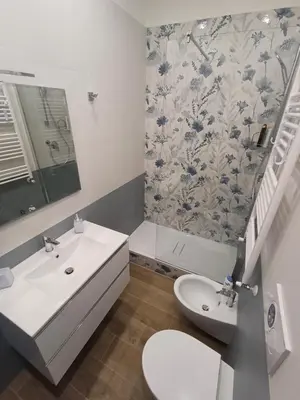 a white bathroom with a sink and a toilet at Ascenza in Trasteverere in Rome