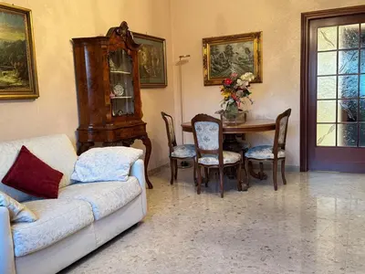 a living room with a couch and a table with chairs at Millys Apartment Rome Centre 
