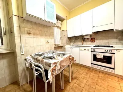 a kitchen with a table with chairs and a stove at Millys Apartment Rome Centre 