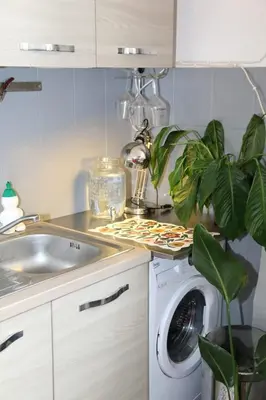 a kitchen with a sink and a washing machine at Tra i Musei Vaticani House in Rome