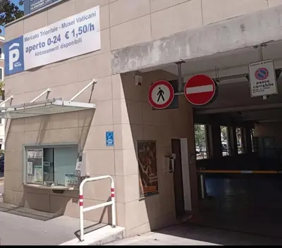a building with two signs on the side of it at Tra i Musei Vaticani House in Rome